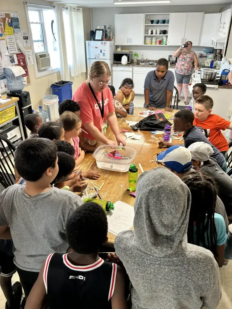 Kids participating in an activity on the table at the Mulgrave Park Caring and Learning Centre during the summer day camp
